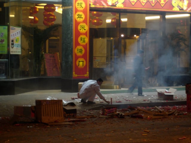 A Chinese man setting off fireworks during Chinese New Year in Shanghai.
