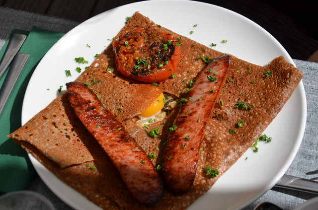 Galettes served with eggs and sausages.