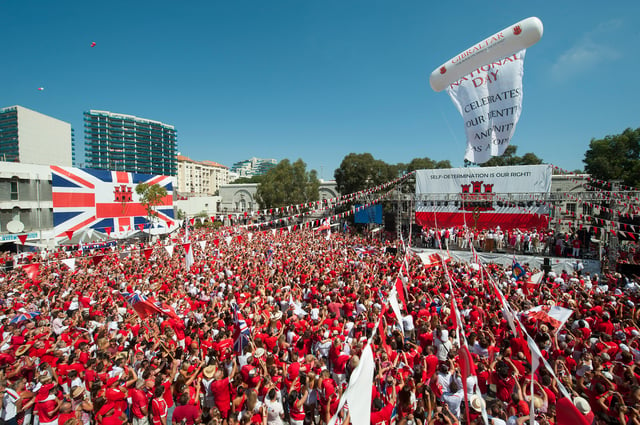 Thousands of Gibraltarians dress in their national colours of red and white during the 2013 Gibraltar National Day celebrations.