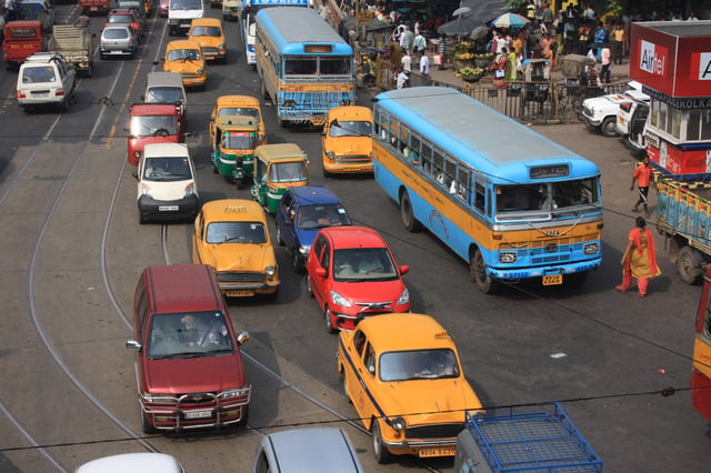 A road in Kolkata showing buses, taxis, auto rickshaws, cars, and other modes of road transport