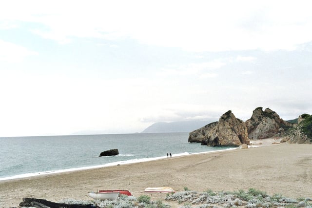Potistika beach. In the middle of the photo the Skamni rock, and at background the mountains of Skiathos island.