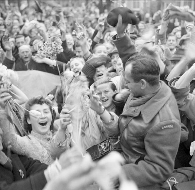 Dutch civilians celebrating the arrival of the I Canadian Corps in Utrecht as the Canadian Army liberates the Netherlands from Nazi occupation