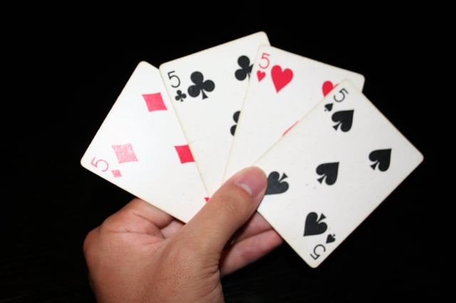 The fives of all four suits in playing cards