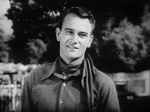 John Wayne as "Singin' Sandy" Saunders in Riders of Destiny (1933)