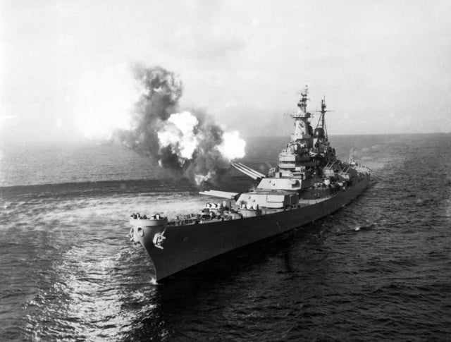 To disrupt North Korean communications, USS Missouri fires a salvo from its 16-inch guns at shore targets near Chongjin, North Korea, 21 October 1950