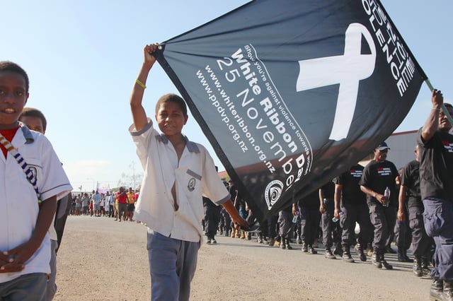 Papua New Guinean children, men and women show their support for putting an end to violence against women during a White Ribbon Day march