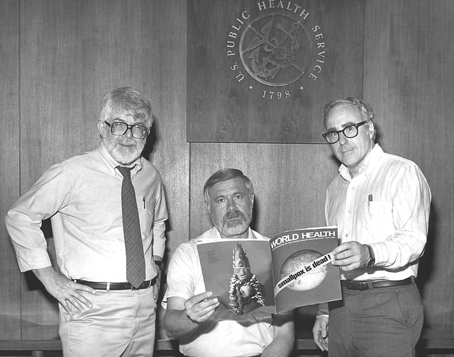 Three former directors of the Global Smallpox Eradication Programme read the news that smallpox had been globally eradicated, 1980.