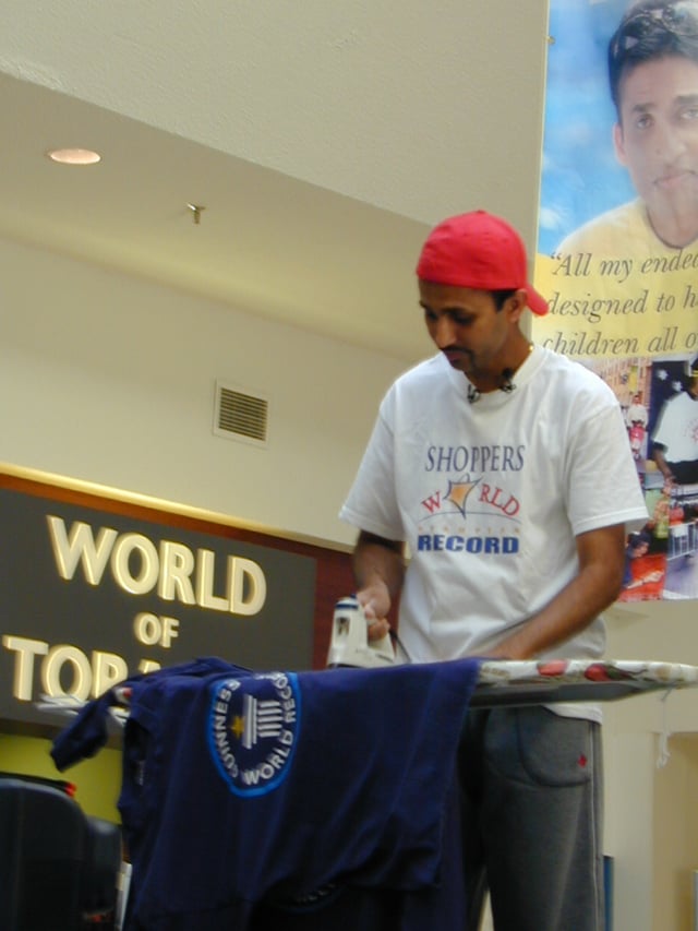 Suresh Joachim Arulanantham is a Tamil Canadian film actor and producer and multiple-Guinness World Record holder who has broken over 50 world records set in several countries in attempts to benefit the underprivileged children around the world. Some world record attempts are more unusual than others: he is pictured here minutes away from breaking the ironing world record at 55 hours and 5 minutes, at Shoppers World, Brampton.