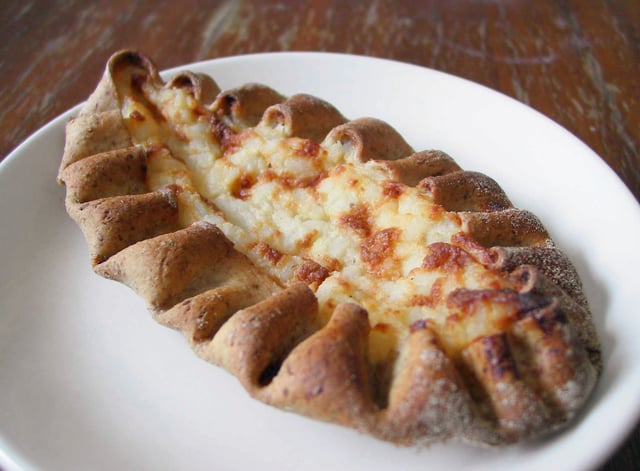 Karelian pasty (karjalanpiirakka) is a traditional Finnish dish made from a thin rye crust with a filling of rice. Butter, often mixed with boiled egg (eggbutter or munavoi), is spread over the hot pastries before eating.
