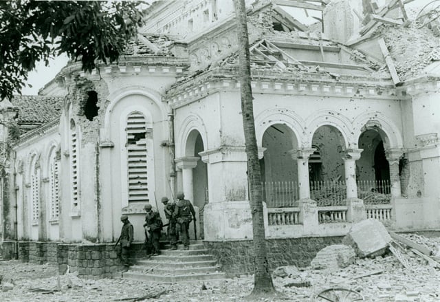 U.S. Marines emerge from the battle-damaged Jeanne d'Arc church in southern Huế