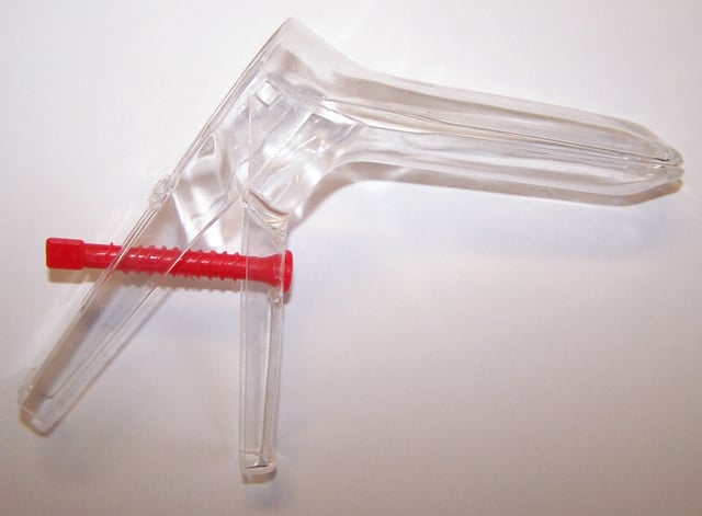 A disposable plastic bi-valved vaginal speculum used in gynecological examination