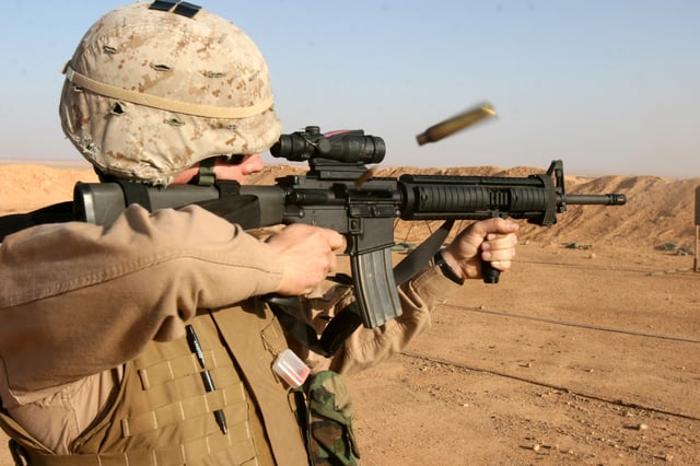 Marine from the US firing an M16A4 equipped with an ACOG