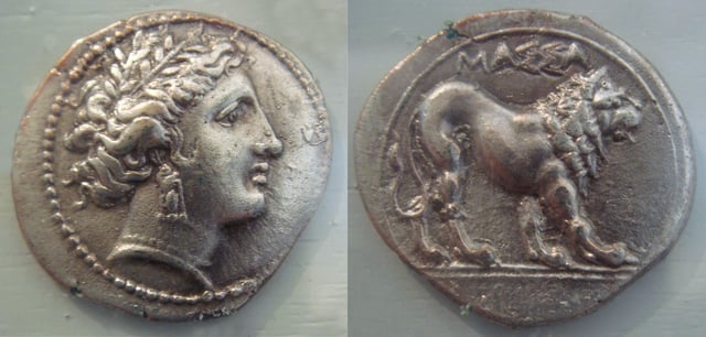 A silver drachma inscribed with MASSA[LIA] (ΜΑΣΣΑ[ΛΙΑ]), dated 375–200 BC, during the Hellenistic period of Marseille, bearing the head of the Greek goddess Artemis on the obverse and a lion on the reverse