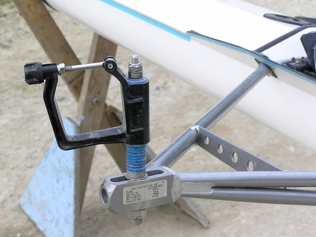 Oars are held in an oarlock at the end of riggers attached to the side of the boat