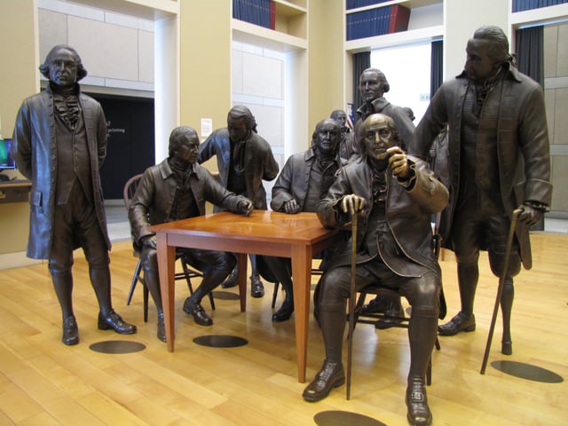 Life-size bronze statue of Benjamin Franklin (seated) in the National Constitution Center, Philadelphia