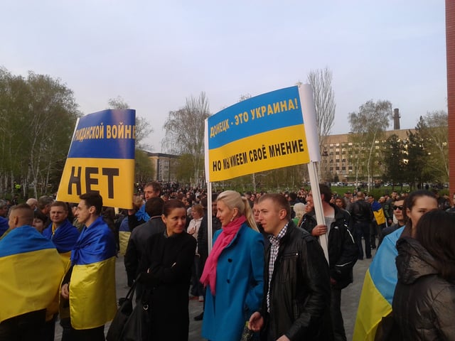 Pro-Ukrainian protesters in Donetsk, 17 April 2014. Signs from left to right: "No to civil war" and "Donetsk is Ukraine, but we have our own opinion"