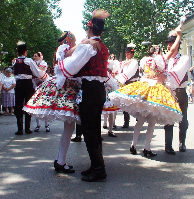 Hungarians dancing csárdás in traditional garments / folk costumes
