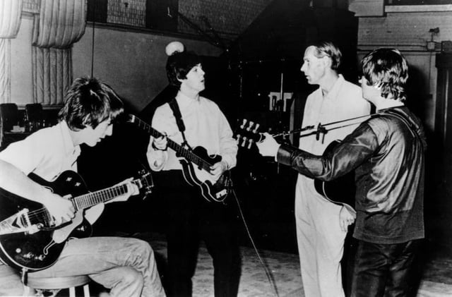 The Beatles working in the studio with their producer, George Martin, circa 1965