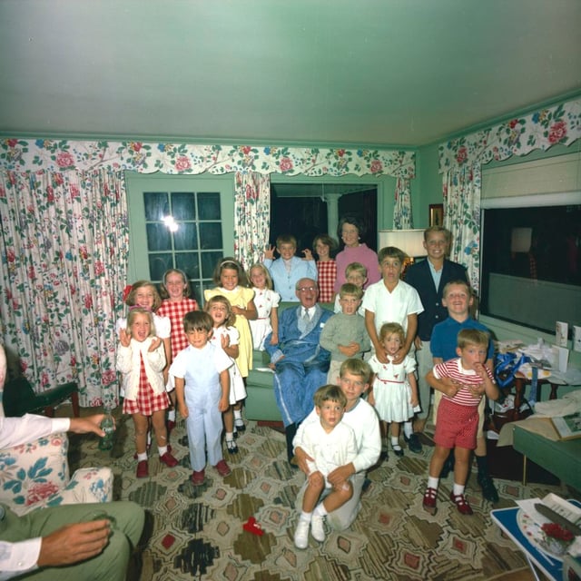 Rose Kennedy (standing, rear) with her husband Joseph P. Kennedy Sr. and grandchildren, 1963. The President is partially in view, holding a Coke bottle.
