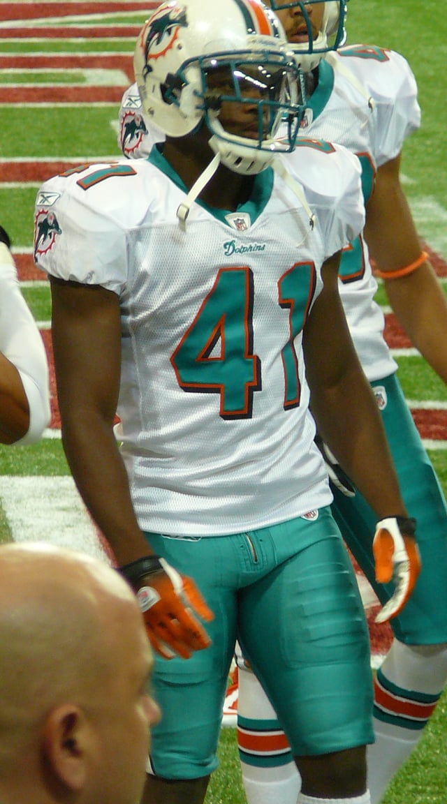 Vince Agnew wearing a helmet. Shoulder pads and thigh pads are visible under his uniform