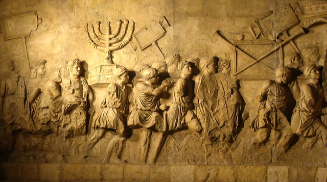 Relief from the Arch of Titus in Rome depicting a menorah and other spoils from the Temple of Jerusalem carried in Roman triumph.