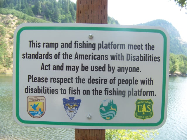 The ADA sets standards for construction of accessible public facilities. Shown is a sign indicating an accessible fishing platform at Drano Lake, Washington.