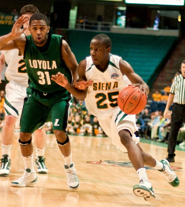 Siena guard Ronald Moore dribbles toward the basket in a game against Loyola in January 2010.