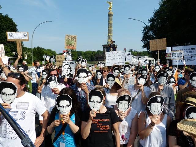 Protesters against NSA data mining in Berlin wearing Chelsea Manning and Edward Snowden masks