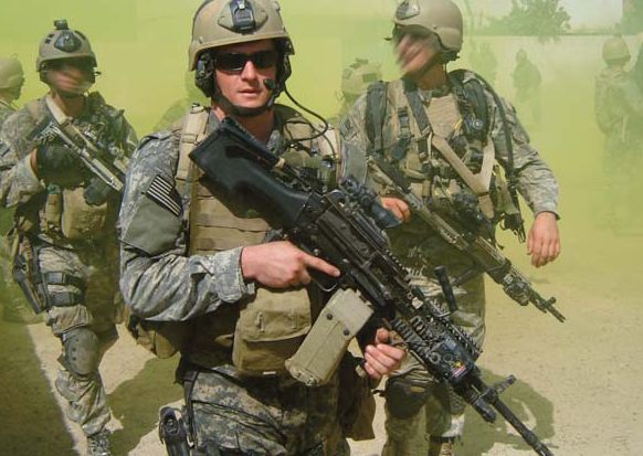 Petty Officer Michael A. Monsoor, 2nd Navy SEAL killed in Iraq. This photo was taken during an extraction after a firefight, and the smoke was used to conceal their movements from the enemy.