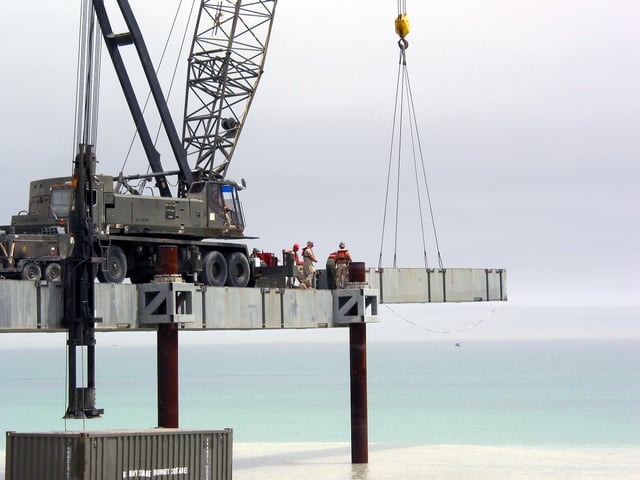 US Navy 030404-N-1050K-023U.S. Seabees from ACBs 1 and 2 place a deck section in the assembly of the Elevated Causeway System-Modular (ELCAS (M)) at Camp Patriot, Kuwait (Apr 4, 2003)  It was the first time the ELCAS/M (length 1,400-feet) was assembled in a combat operation.