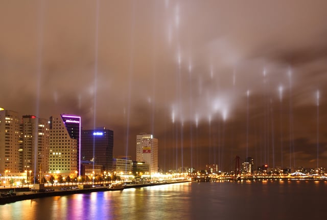 Rotterdam waterfront, with spotlights shining into the air to commemorate the Rotterdam Blitz