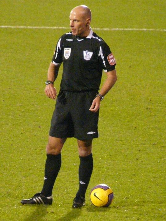 The referee officiates in a football match