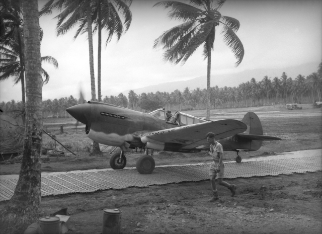 A P-40E-1 piloted by the ace Keith "Bluey" Truscott, commander of No. 76 Squadron RAAF, taxis along Marston Matting at Milne Bay, New Guinea in September 1942.