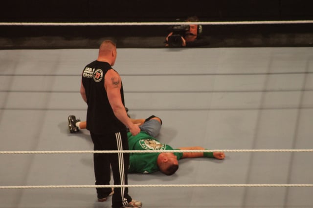 After executing an F-5, Lesnar stands over John Cena the night after WrestleMania XXVIII.