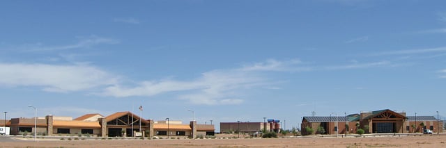New buildings in Alamogordo: PreCheck, Inc. headquarters, Aviator 10 Theater, and the US Department of Agriculture / Forest Service building.