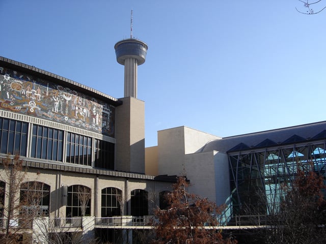 The Henry B. González Convention Center and Lila Cockrell Theater along the San Antonio River Walk.  The Tower of the Americas is visible in the background.