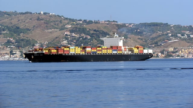 A cargo ship cruises towards the Strait of Messina