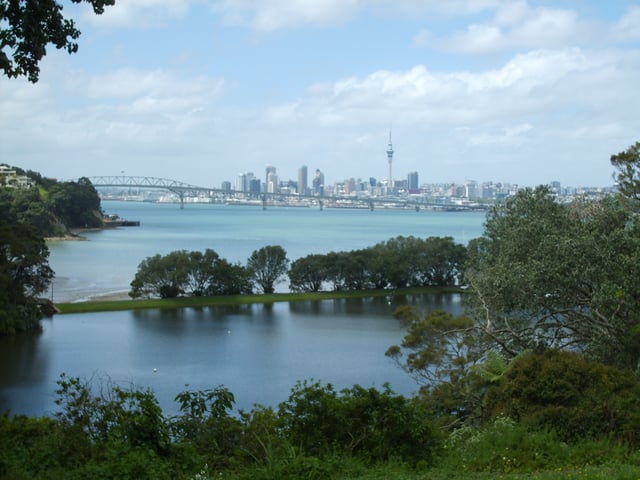 A view over Chelsea Sugar Refinery's lower dam towards Auckland Harbour Bridge and the CBD