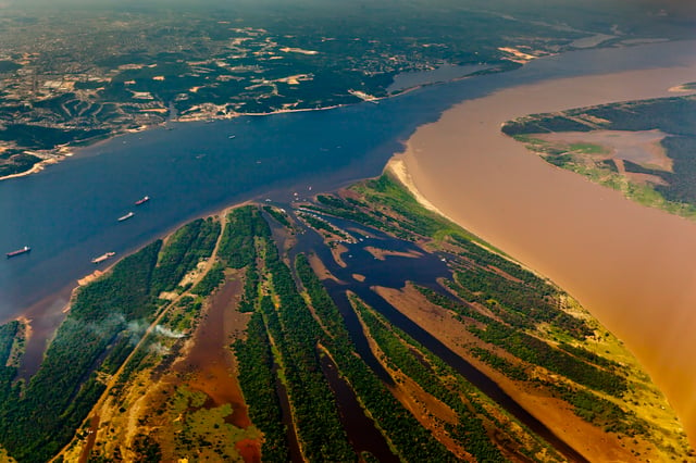 The confluence of the Rio Negro (black) and the Rio Solimões (turbid) near Manaus, Brazil.