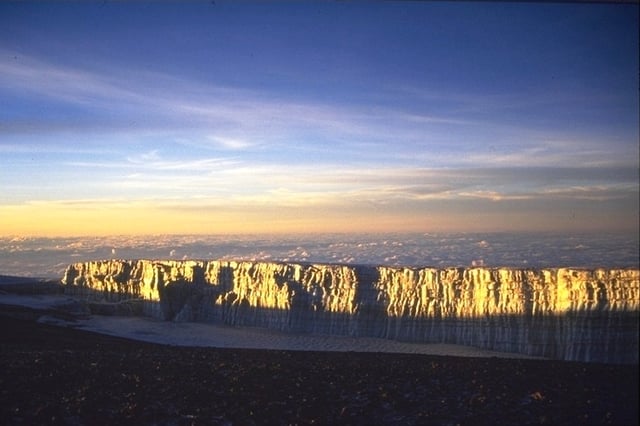 A vertical glacier margin wall as seen from Gilman's Point on the crater rim at a sunrise in 1998