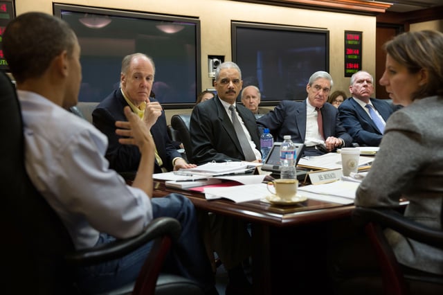 Mueller at the White House in April 2013, discussing the Boston Marathon bombing, with (from left) President Obama, National Security Advisor Tom Donilon, Attorney General Eric Holder, Director of CIA John O. Brennan, and Lisa Monaco, Assistant to the President for Homeland Security and Counterterrorism