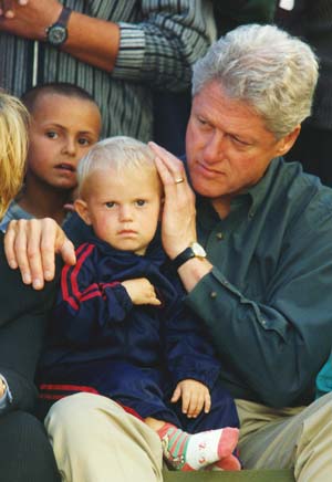 US President Bill Clinton with Albanian children during his visit to Kosovo, June 1999