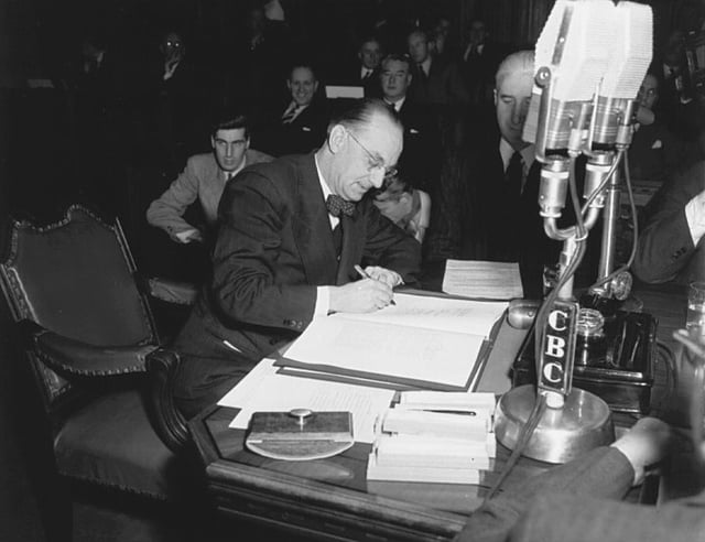 Joey Smallwood signs a document that brings Newfoundland into the Canadian Confederation, 1948
