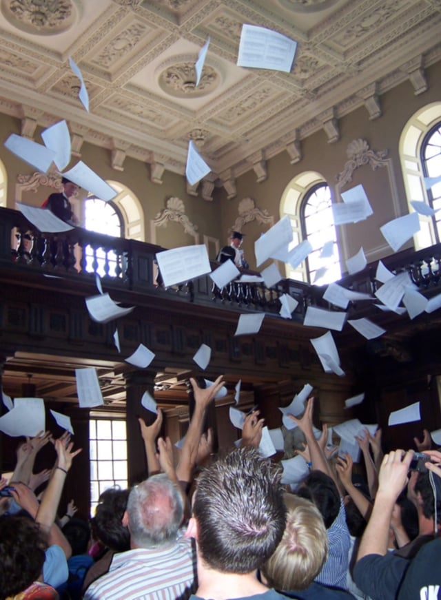 Results for the Cambridge Mathematical Tripos are read out inside Senate House and then tossed from the balcony