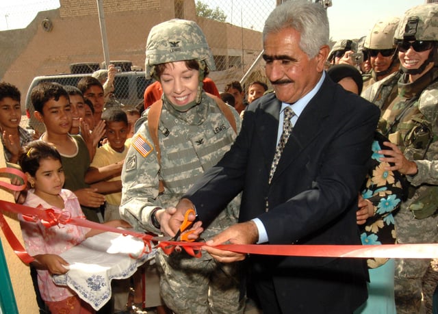 Colonel Debra Lewis, the Gulf Region Division Central District commander with Sheik O'rhaman Hama Raheem, an Iraqi councilman, celebrate the opening of a new women's center in Assriya Village that the Corps helped construct in 2006.