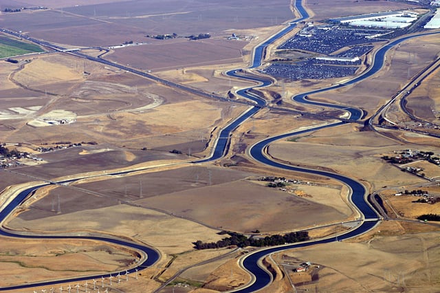 An aerial view of the Delta–Mendota Canal (left) and the California Aqueduct (right), at the Interstate 205 crossing west of Tracy, conveying water from Northern to Southern California