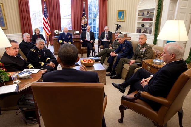 President Obama meeting in the Oval Office with Secretary Gates, the Joint Chiefs of Staff, and the Commandant of the Coast Guard on the eve of publication of a DoD report on the repeal of DADT.
