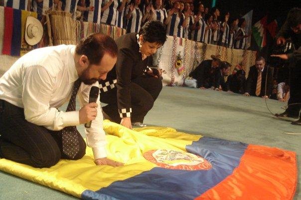 Pentecostal pastors pray over the Ecuadorian flag.