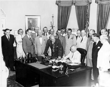 President Harry Truman signs the National Security Act Amendment of 1949