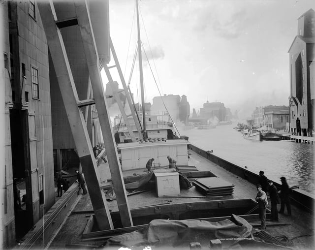 Workers unload wheat into an elevator along the Buffalo River in 1900